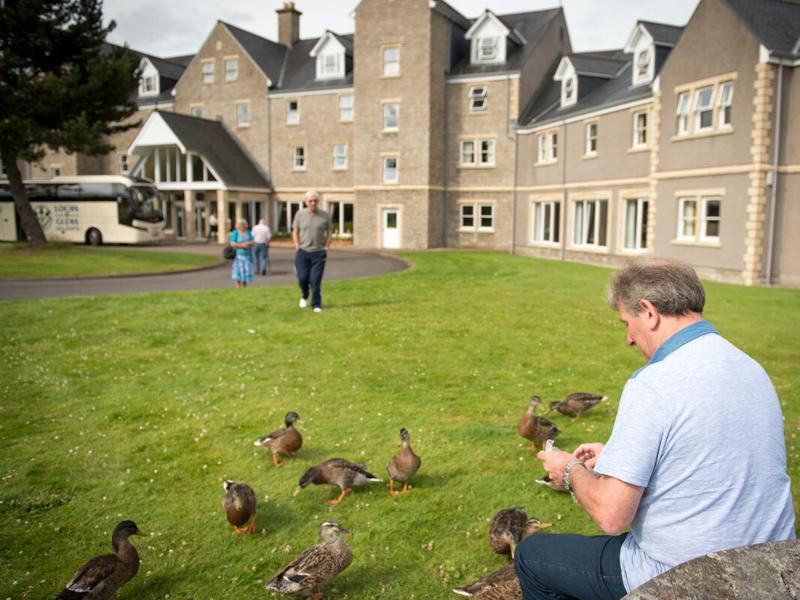 Man feeding the ducks at Loch Tummel